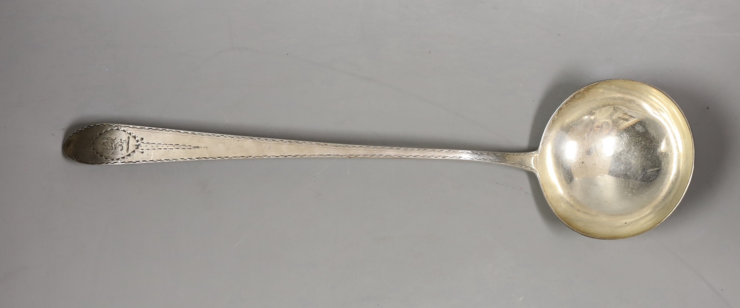 A George III Irish silver soup ladle, with bright cut and crested handle, Dublin 1809, 5.5oz
